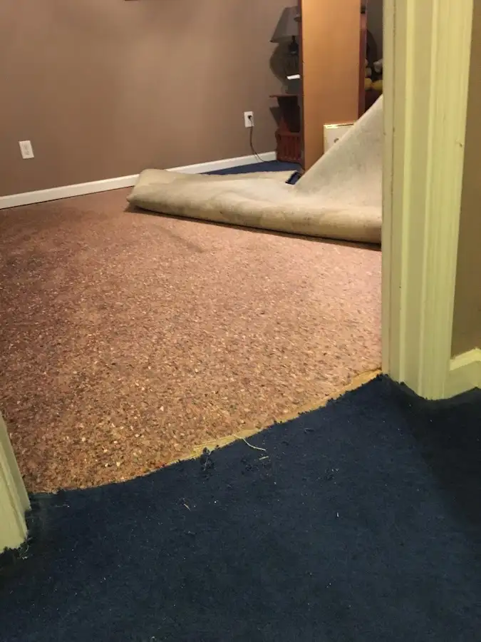 Carpet pad removal revealing water damage during Water Mitigation Services in Atlantic City